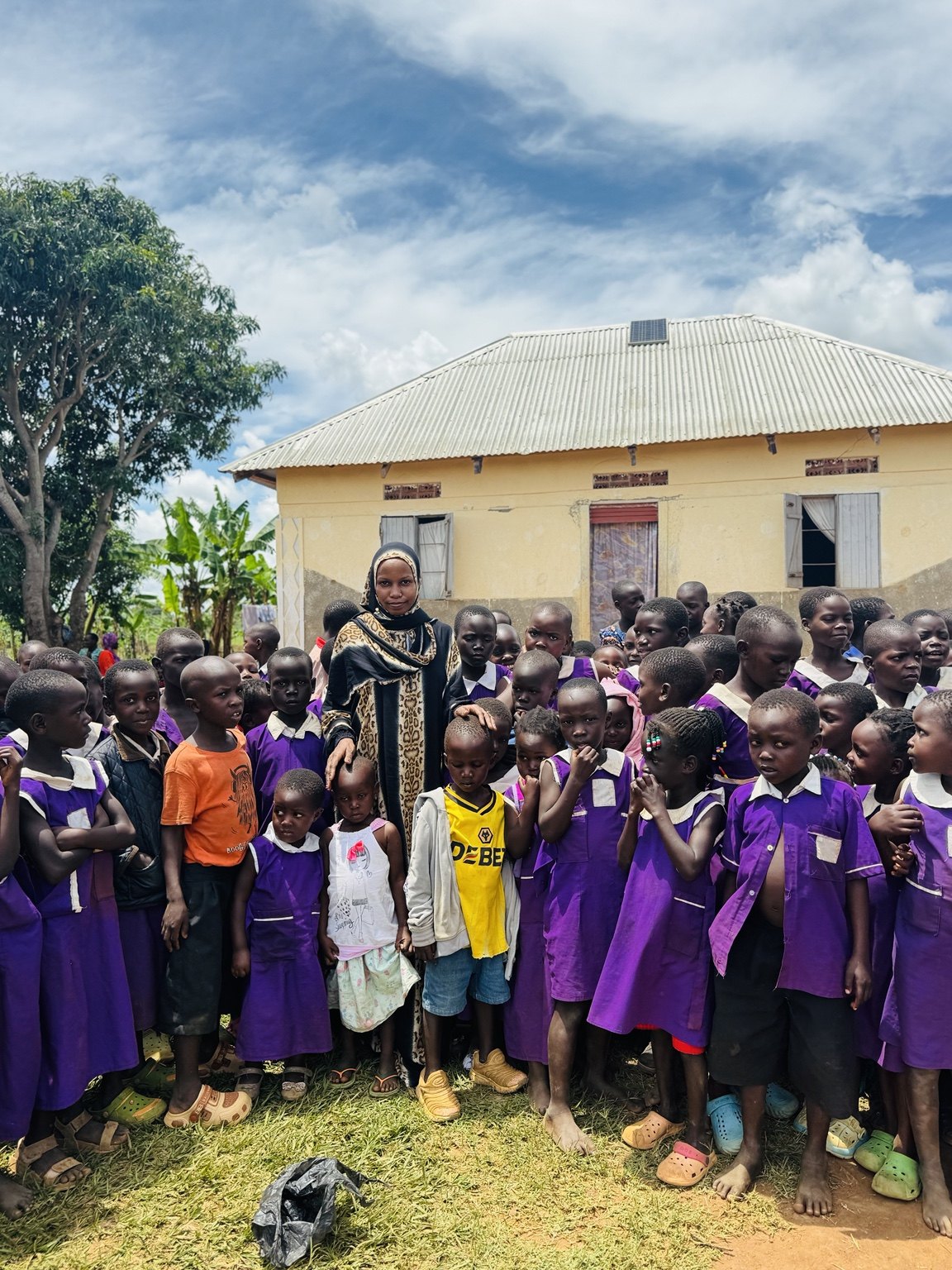 Children gathered with a community caregiver