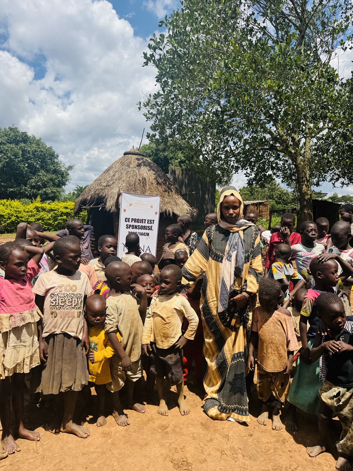Children gathered with a community representative