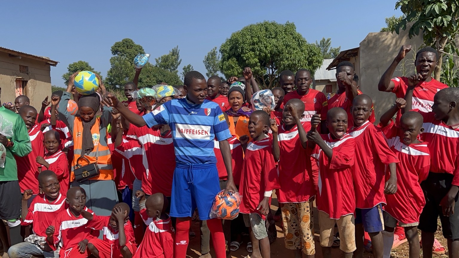 Children celebrating with footballs
